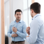 A man Motivating himself in-front of a mirror