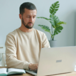 a young man with a laptop