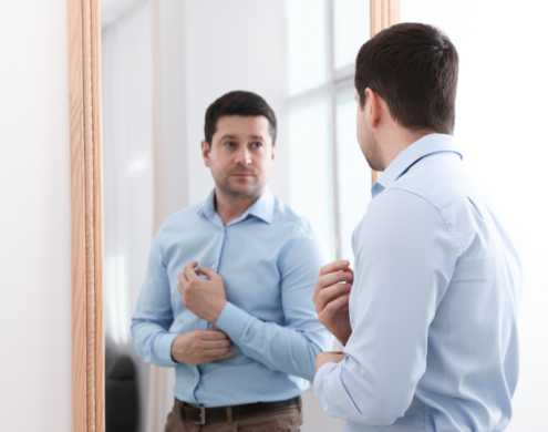 A man Motivating himself in-front of a mirror