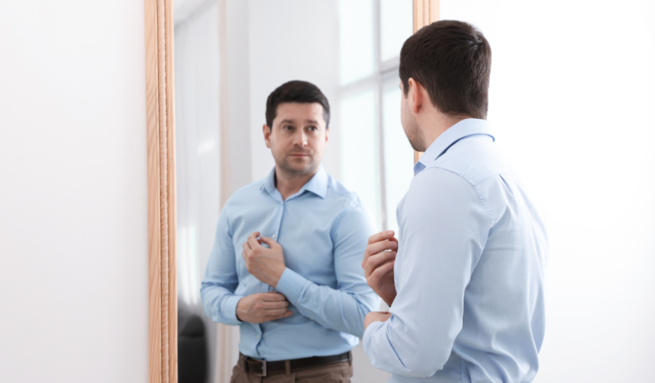 A man Motivating himself in-front of a mirror